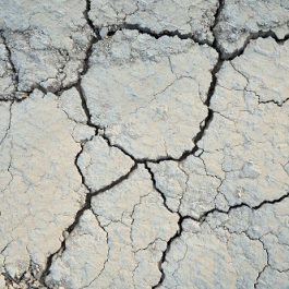 Above view of split soil in large parts. Concept of drought cracked texture background.