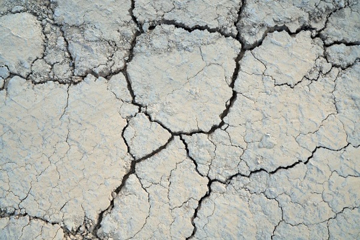 Above view of split soil in large parts. Concept of drought cracked texture background.